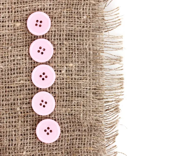 Colorful sewing buttons on sackcloth — Stock Photo, Image