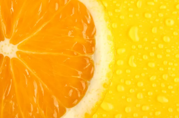 Slice of orange with drop on yellow background — Stock Photo, Image