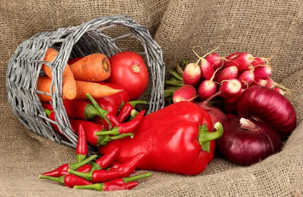 Färska röda grönsaker på säckväv bakgrund — Stockfoto