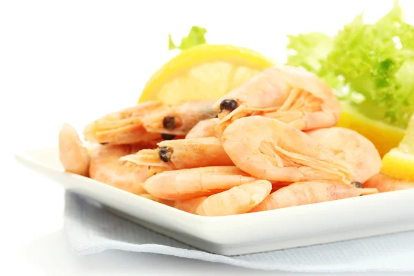 Boiled shrimps with lemon and lettuce leaves on plate, isolated on white — Stock Photo, Image