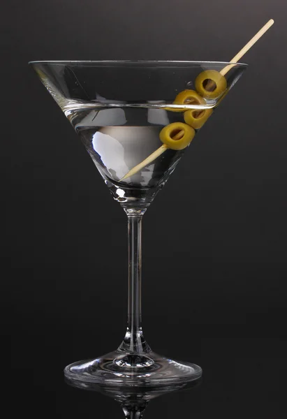 Martini glass and olives on grey background — Stock Photo, Image