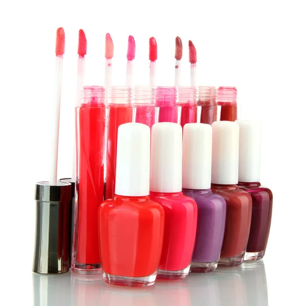 Beautiful lip glosses and nail polish bottles, isolated on white — Stock Photo, Image