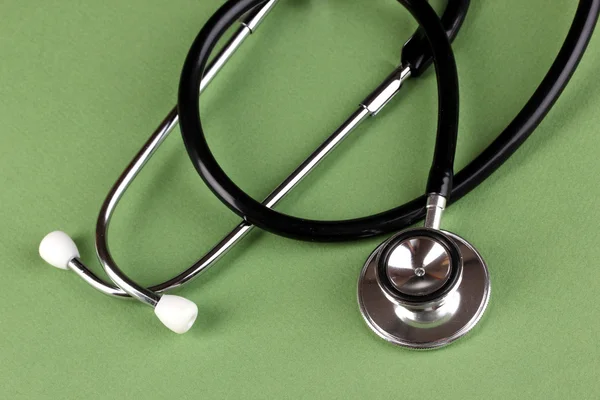 Stethoscope on green background — Stock Photo, Image