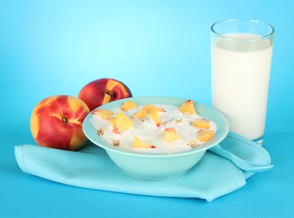 Tasty dieting food and glass of milk, on blue background — Stock Photo, Image