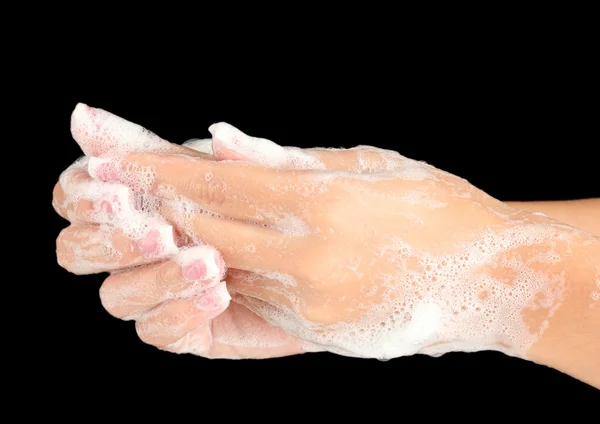 Woman's hands in soapsuds, on black background close-up — Stock Photo, Image