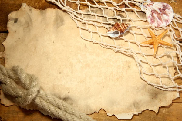 Old paper, fishing net and rope on wooden table — Stock Photo, Image