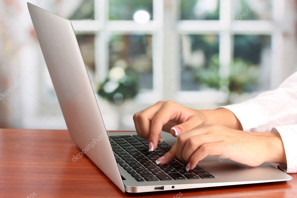 business woman's hands typing on laptop computer, close-up