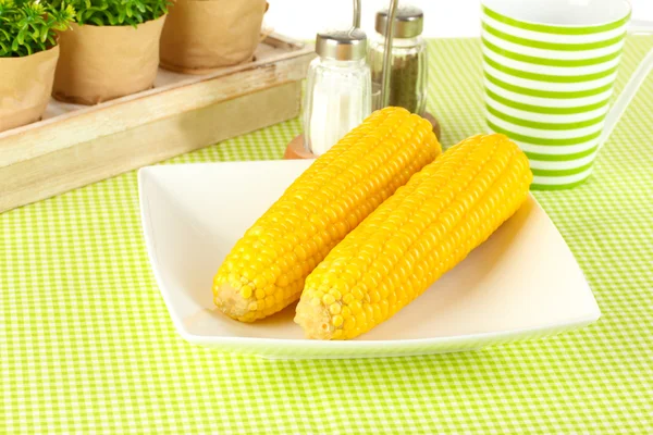 Boiled corn and flowers on a white background — Stock Photo, Image