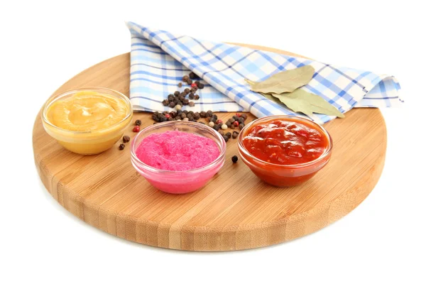 Various sauces on chopping board isolated on white — Stock Photo, Image