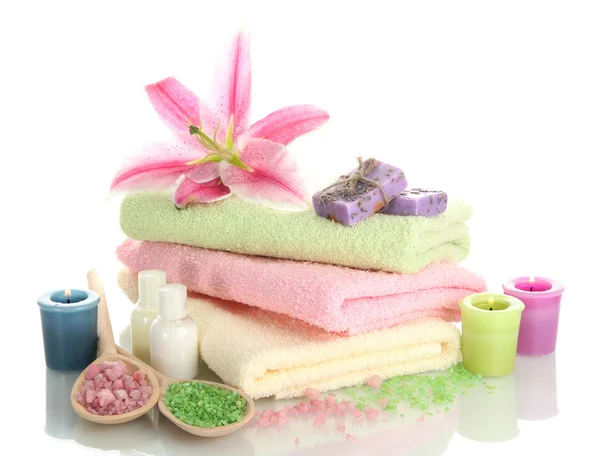 Towels with lily, aroma oil, candles, soap and sea salt isolated on white — Stock Photo, Image