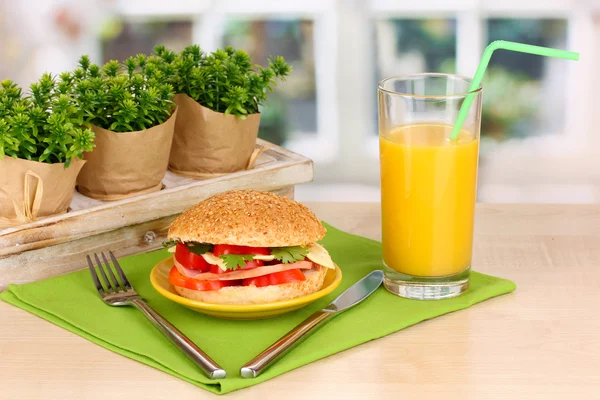 Appetizing sandwich on color plate on wooden table on window background — Stock Photo, Image