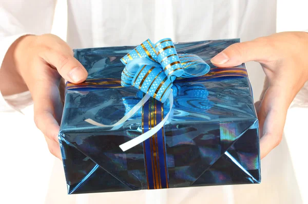 Woman holds a box with a gift on white background close-up — Stock Photo, Image