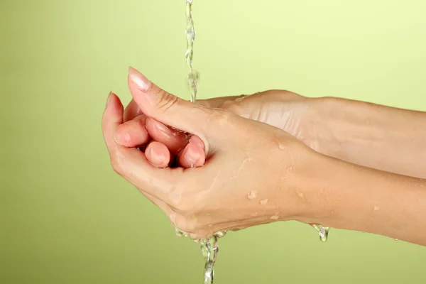 Se laver les mains sur fond vert close-up — Photo