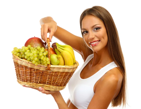 Beautiful young woman with fruits in basket, isolated on white — Stock Photo, Image