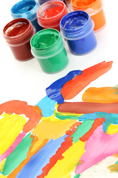 Jars with colorful gouache with a bright picture close-up