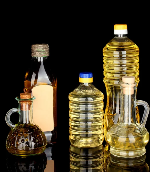 Aceite de oliva y girasol en las botellas y pequeños decantadores aislados en blac — Foto de Stock