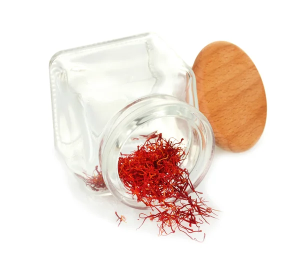 Stigmas of the saffron poured out a glass jar isolated on white — Stock Photo, Image