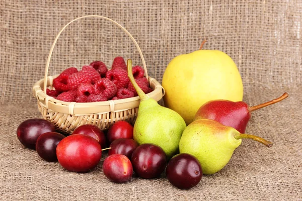 Ripe sweet fruits and berries on sackcloth — Stock Photo, Image