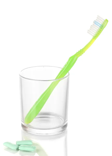 Toothbrush in glass and chewing gum isolated on white — Stock Photo, Image