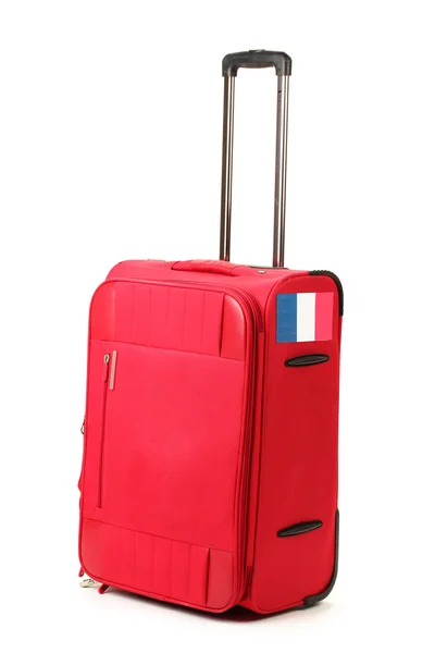 Red suitcase with sticker with flag of France isolated on white — Stock Photo, Image