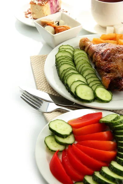 Roast chicken with french fries and vegetables, cup of tea and dessert, is — Stock Photo, Image