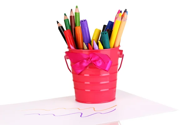 Colorful pencils and felt-tip pens in pink pail isolated on white — Stock Photo, Image