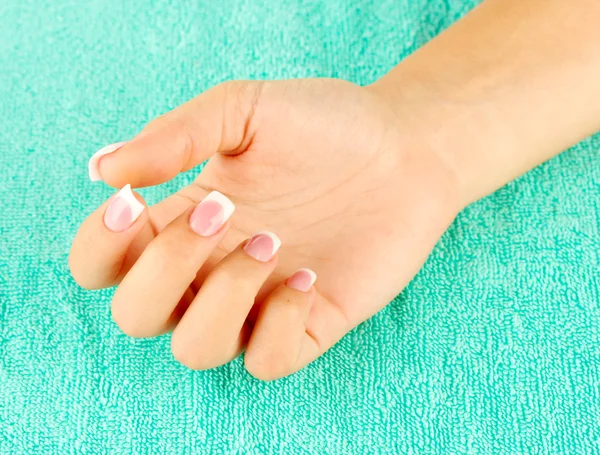 Woman's hand on blue terry towel, close-up — Stock Photo, Image