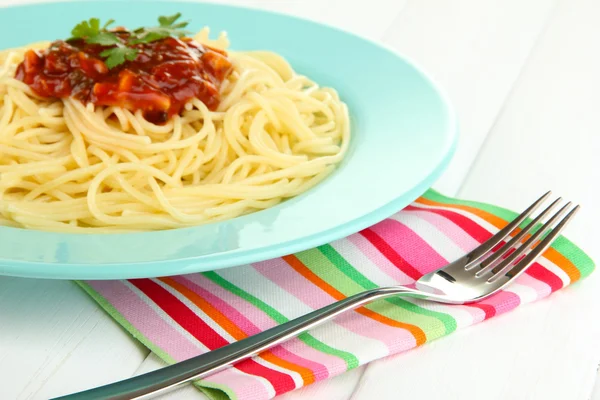 Italian spaghetti in plate on wooden table — Stock Photo, Image