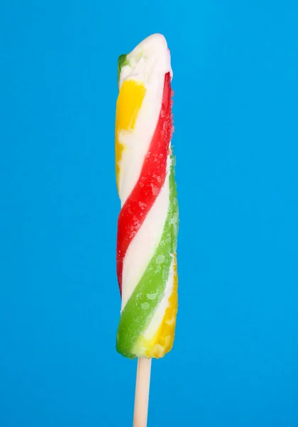 Colorful fruit juice ice on blue background — Stock Photo, Image