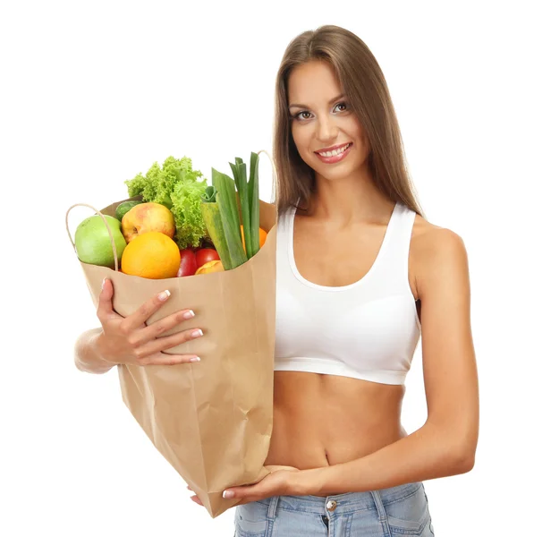 Mooie jonge vrouw met groenten en fruit in boodschappentas, geïsoleerd — Stockfoto