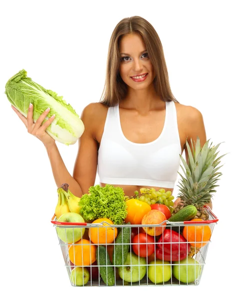 Beautiful young woman with fruits and vegetables in shopping basket, isolat — Stock Photo, Image