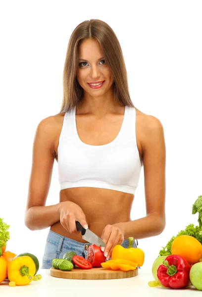 Beautiful young woman cutting vegetables, isolated on white — Stock Photo, Image