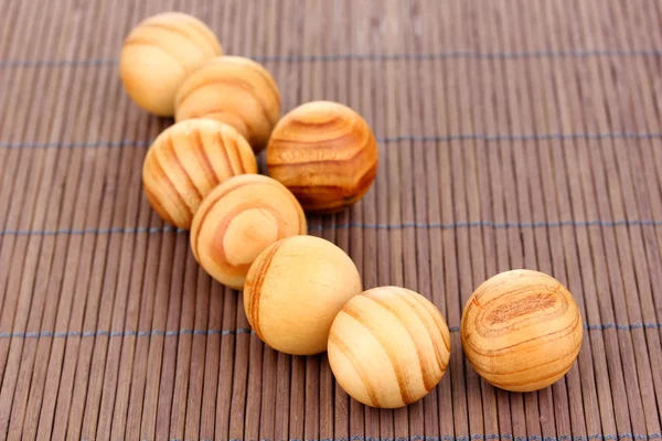 Boules en bois sur tapis de bambou — Photo