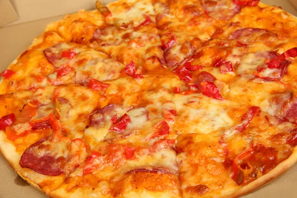 Tasty pizza in box close-up — Stock Photo, Image