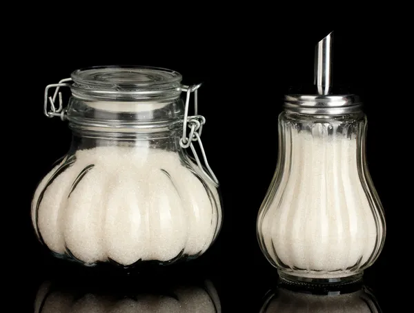 Sugar bowls with crystal sugar isolated on black background close-up — Stock Photo, Image