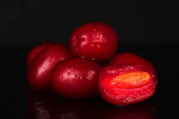 Fresh cornel berries isolated on black — Stock Photo, Image