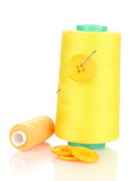 Yellow bobbin with needle and buttons isolated on white — Stock Photo, Image