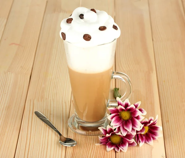 Glass of fresh coffee cocktail awith flower on wooden background — Stock Photo, Image