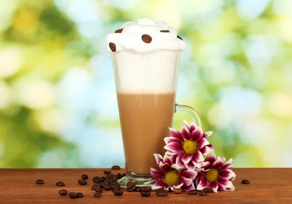 glass of fresh coffee cocktail on green background