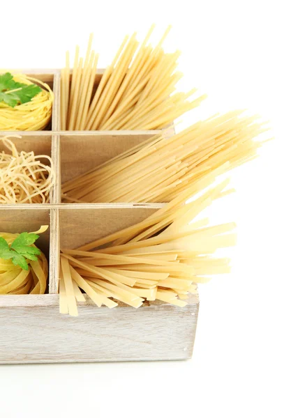 Nine types of pasta in wooden box sections close-up isolated on white — Stock Photo, Image