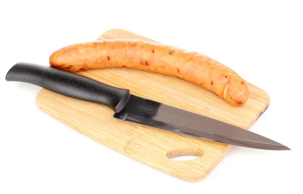 Tasty sausage on chopping board isolated on white — Stock Photo, Image