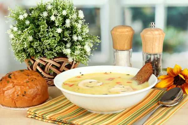 Fragrant soup in white plate on table on window background close-up — Stock Photo, Image