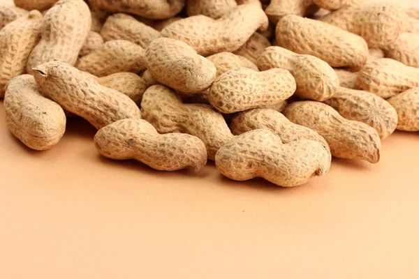 Tasty peanuts, on beige background — Stock Photo, Image