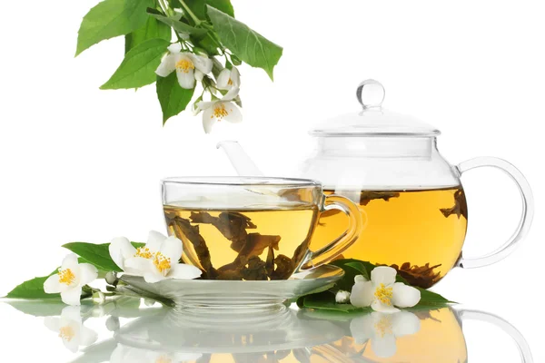 Green tea with jasmine in cup and teapot isolated on white Stock Photo
