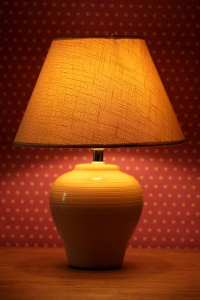 Table lamp on wallpaper background Stock Picture