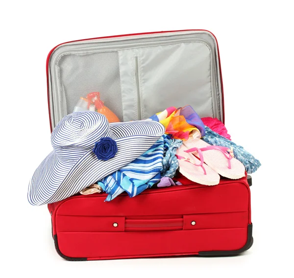 Suitcase with summer clothes, a hat and suntan isolated on white — Stock Photo, Image