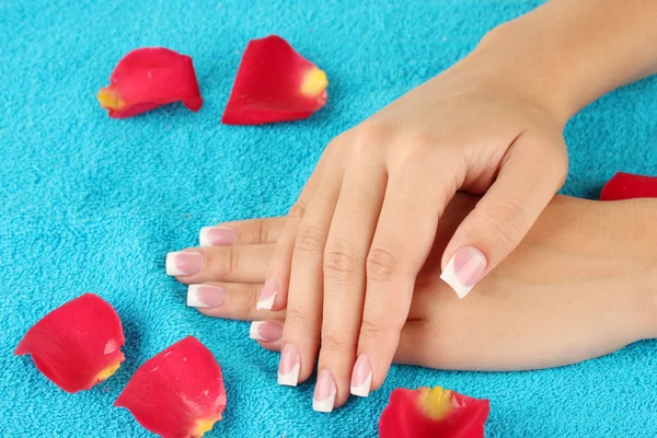 Woman's hands on blue terry towel, close-up — Stock Photo, Image