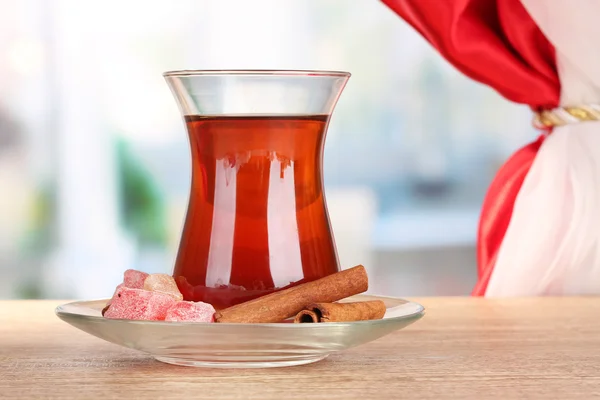 Glass of Turkish tea and rahat lokum, on wooden table — Stock Photo, Image