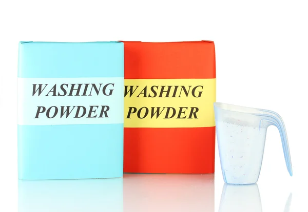 Boxes of washing powder with blue measuring cup isolated on white — Stock Photo, Image