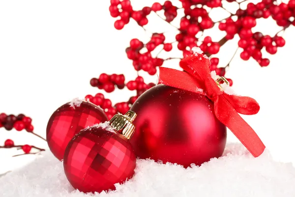 Beautiful red Christmas balls on snow, isolated on white — Stock Photo, Image